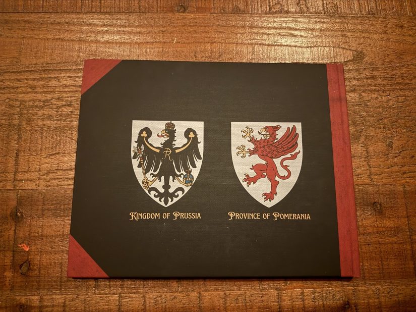 Cover of a family history book featuring the titles 'Kingdom of Prussia' and 'Province of Pomerania' alongside heraldic shields.