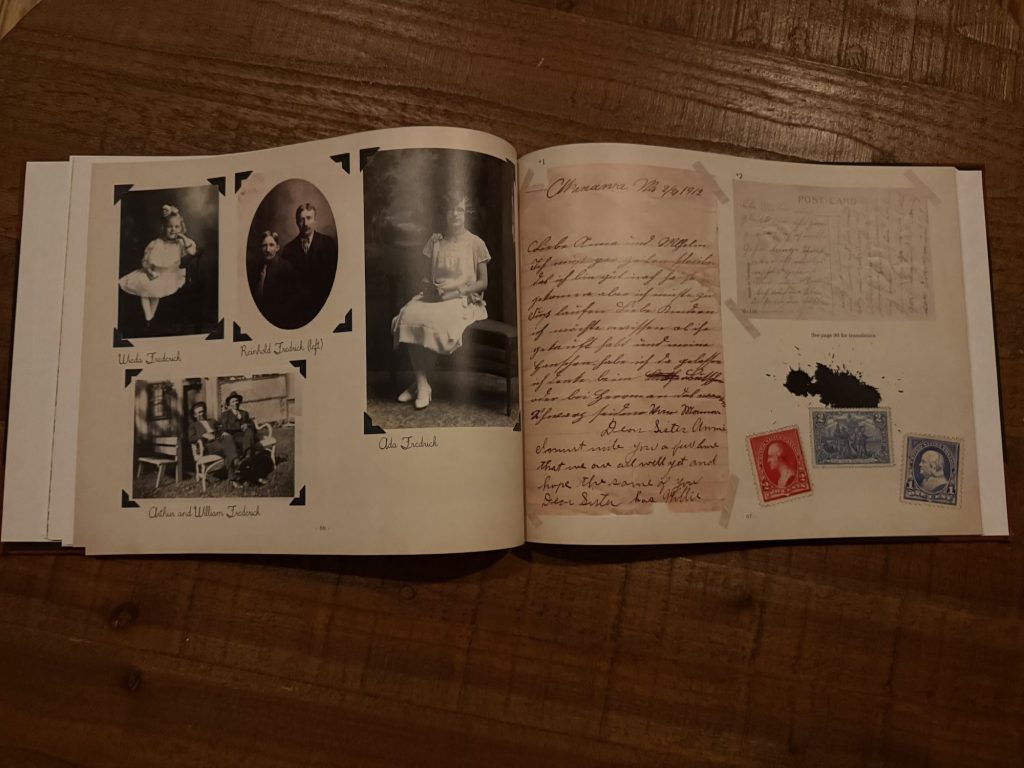 A spread from a family history book featuring black-and-white photos of relatives, handwritten notes, and vintage stamps on a wooden table.